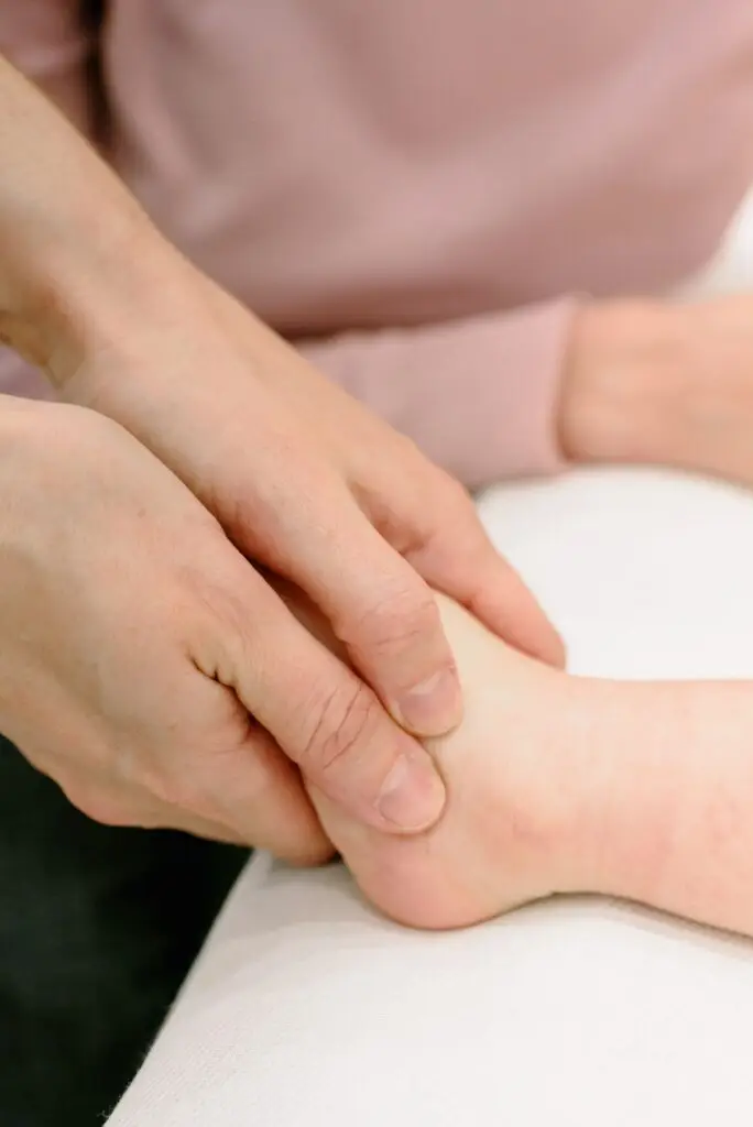 Close-up image of a calming foot massage with hands providing soothing touch.